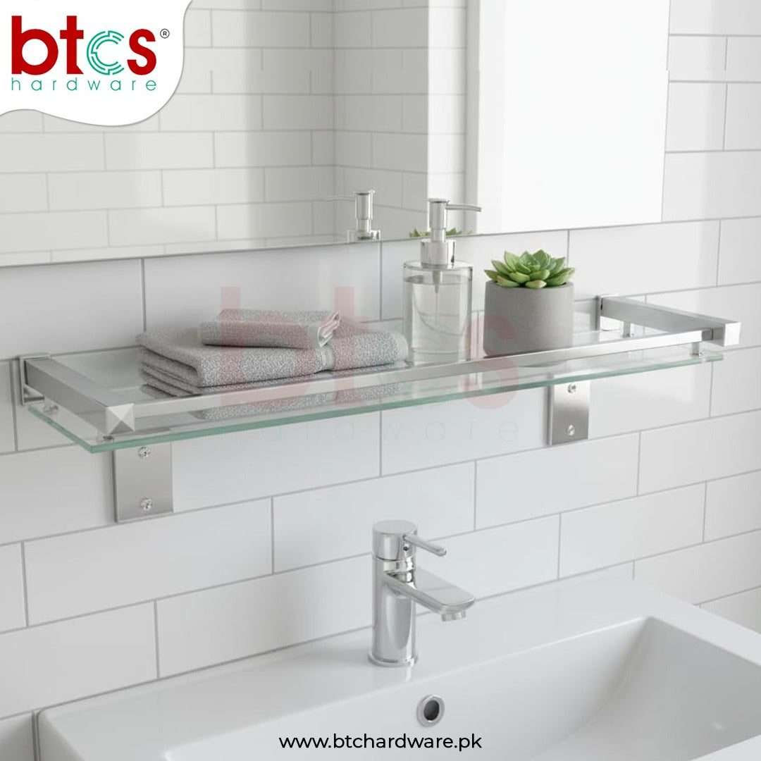 Bathroom setup with glass shelf, sink, and decorative elements on a tiled wall.