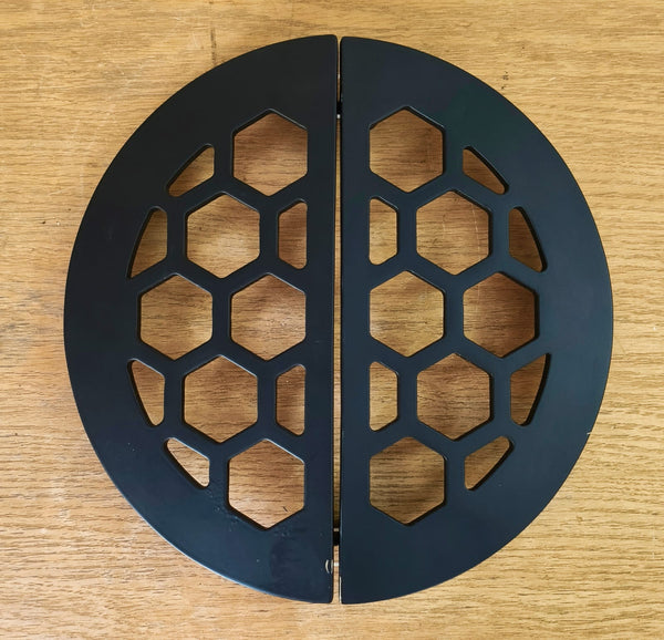 Black metal bookends with hexagonal pattern on a wooden surface