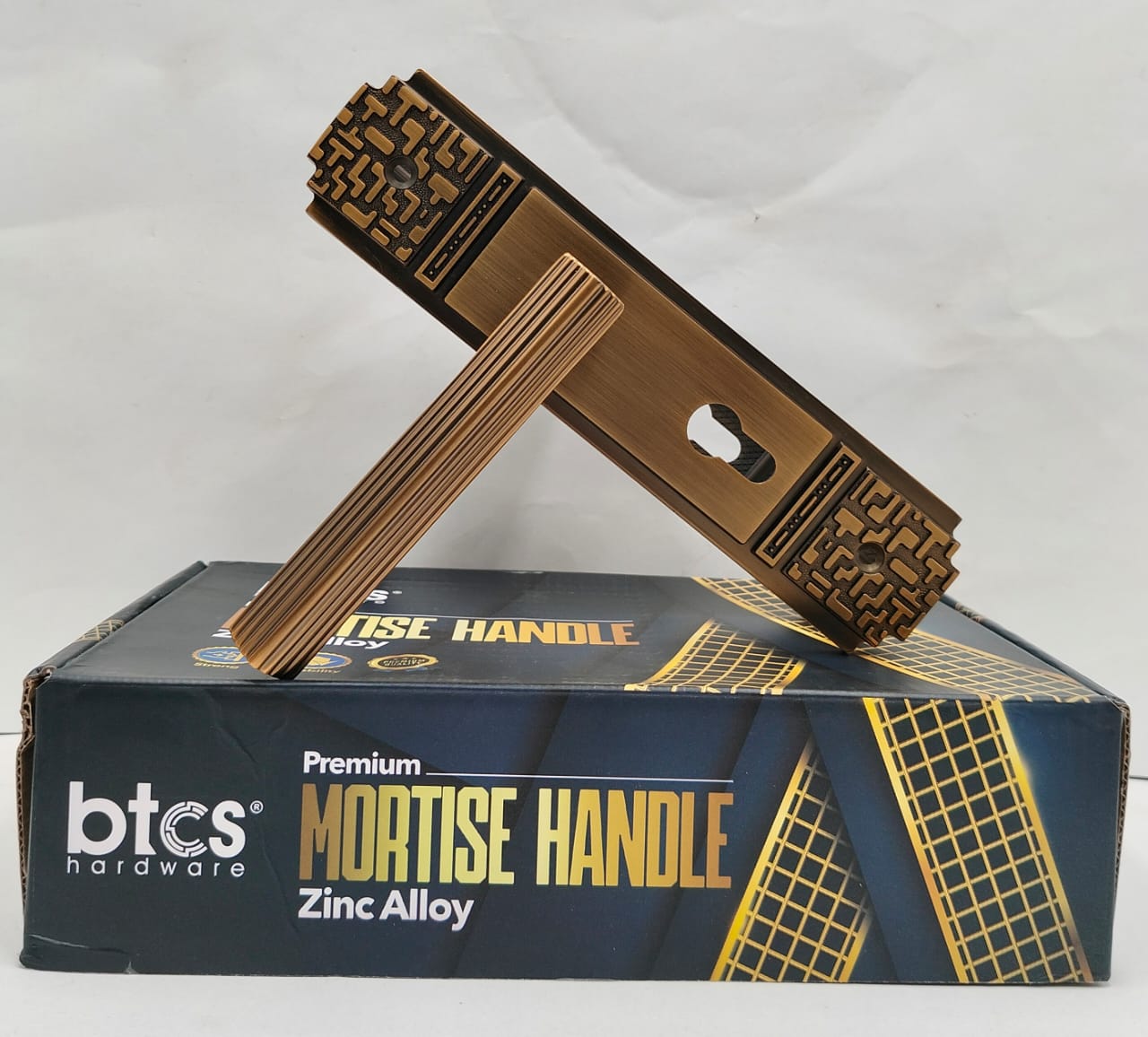 Bronze mortise handle on a box labeled 'btcs hardware' with 'Premium Mortise Handle Zinc Alloy'.