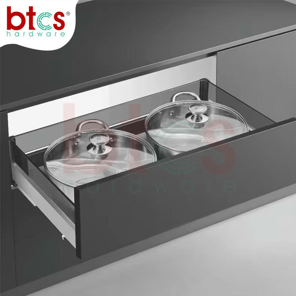 Cabinets with open drawers containing covered pots, branded 'btcs hardware'.