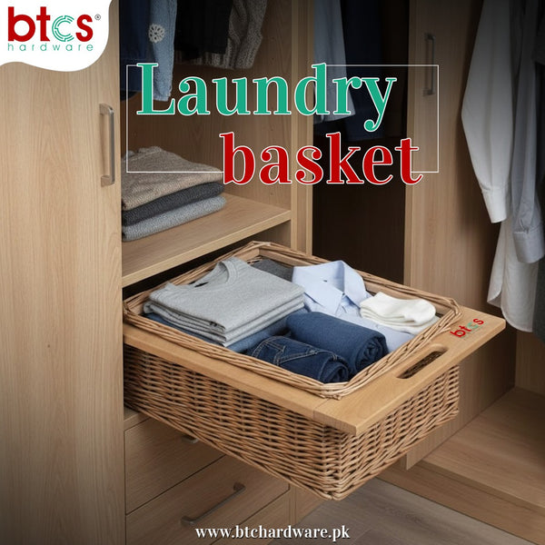 Wicker laundry basket with folded clothes inside a wooden wardrobe, branded 'btcs hardware'.