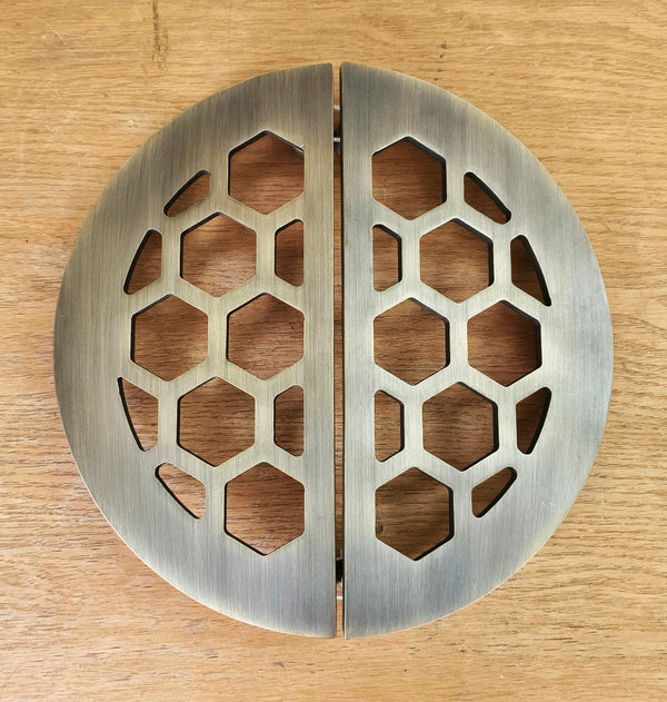 Round metal object with honeycomb pattern on a wooden surface