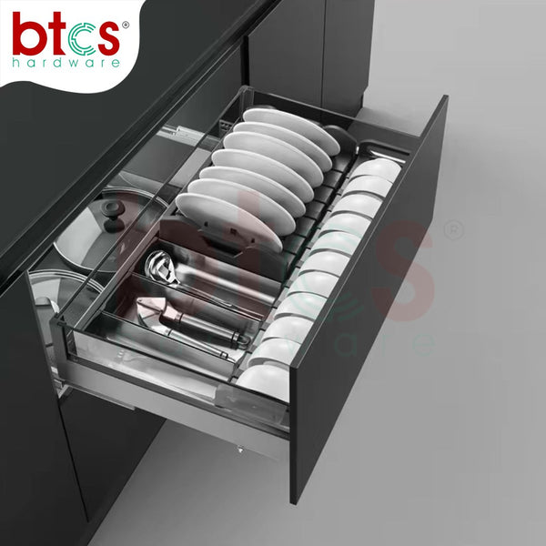 Open kitchen drawer with utensils and plates, featuring BTCs hardware logo.