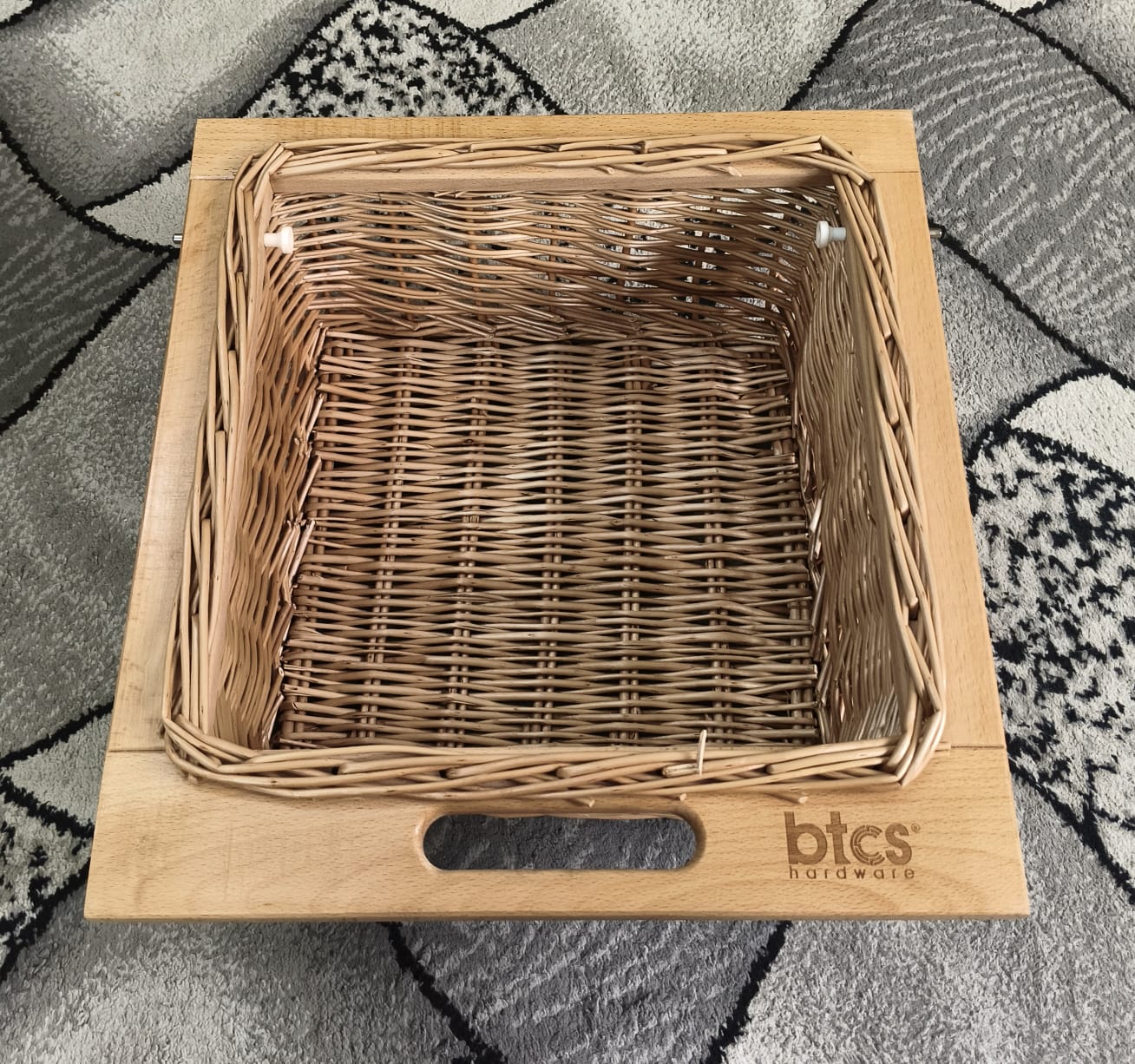 Wicker basket with wooden frame on a textured surface