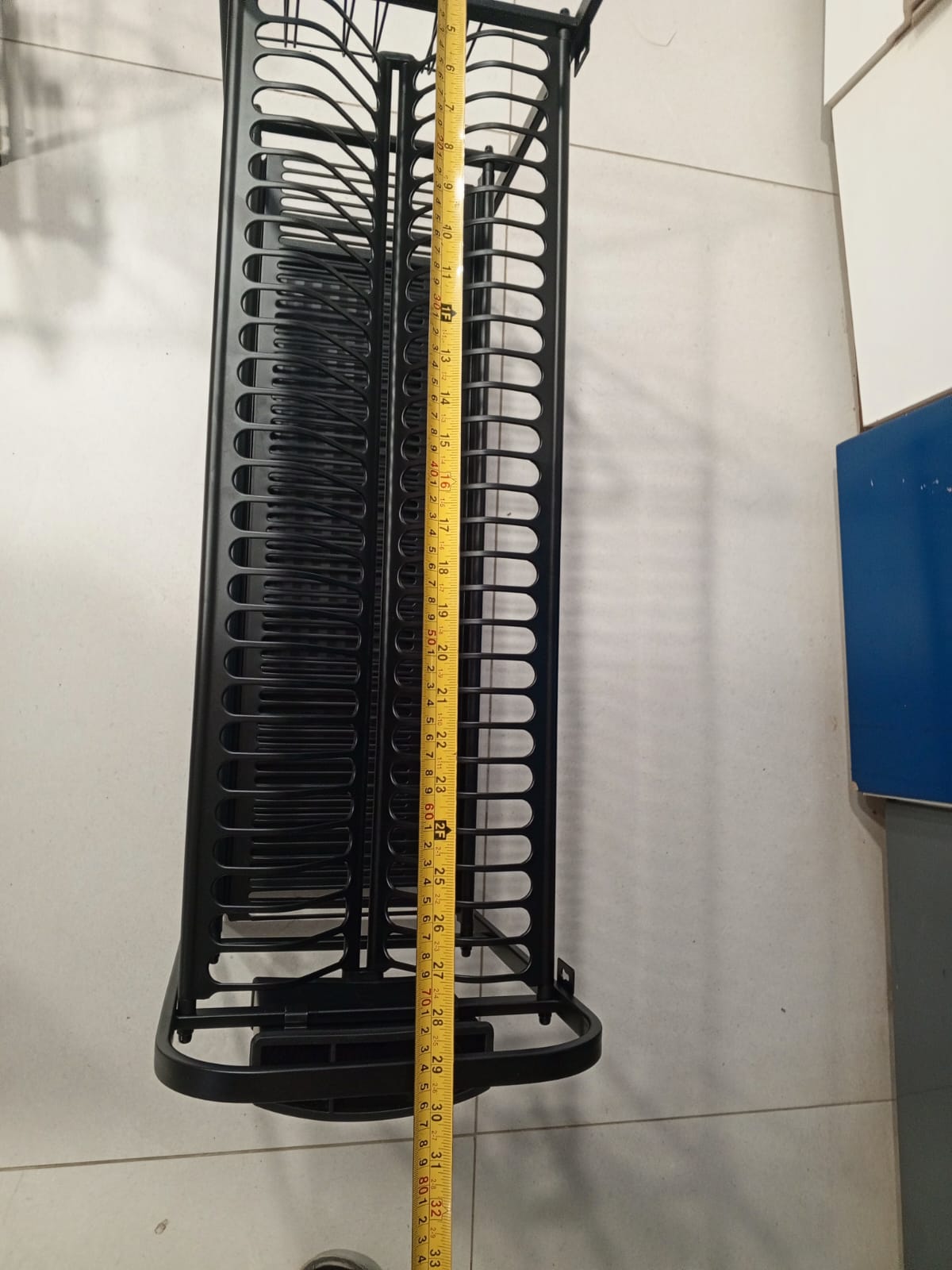 Black metal basket with a measuring tape